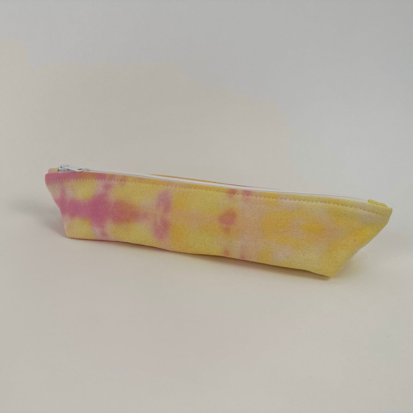 Back view of a Miche Niche zipper pouch in a hand dyed pink and yellow tie dye pattern